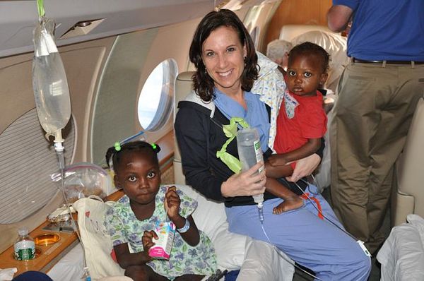 Nurse Sandy Roberts accompanies children on the flight to Massachusetts from Haiti, which was underwritten by Western Massachusetts philanthropists Michael and Lisa Kittredge
